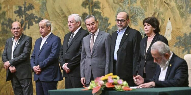 China's Foreign Minister Wang Yi, fourth left, looks on, while hosting an event of signing of the "Beijing declaration" between Palestinian factions, Fatah and Hamas, at the Diaoyutai State Guesthouse in Beijing, Tuesday, July 23, 2024. Mahmoud al-Aloul of Fatah, third left, and Mussa Abu Marzuk of Hamas, third right, are seen. (Pedro Pardo/Pool Photo via AP)