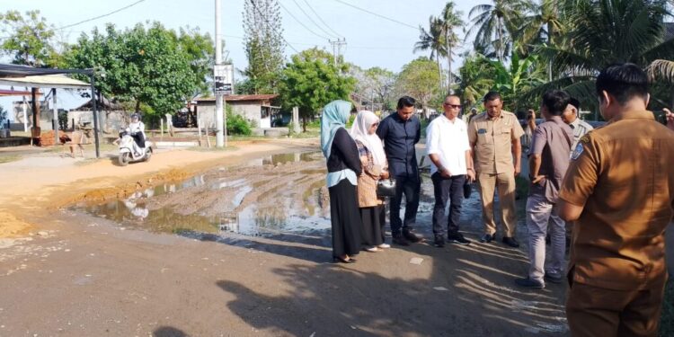 Anggota Komisi C DPRK Lhokseumawe, Puteh Usman bersama pihak PUPR meninjau jalan yang rusak. ( Dok : DPRK Lhokseumawe )